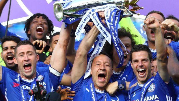 Gary Cahill and John Terry lift the Premier League trophy at Stamford Bridge.