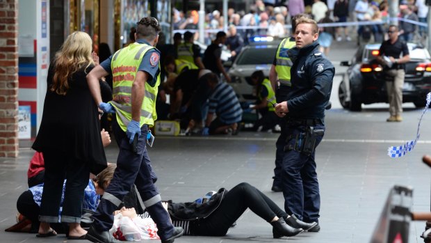 Police and paramedics with an injured pedestrian.