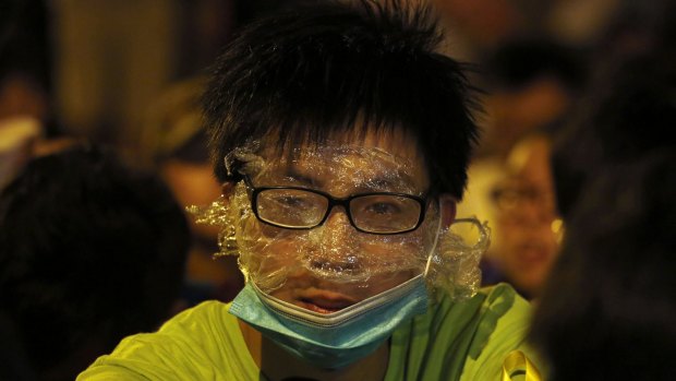 Under wraps: A protester wears rudimentary protection against pepper spray during a confrontation with the police, after a rally for the October 1 "Occupy Central" civil disobedience movement in Hong Kong. 