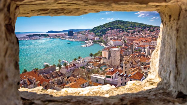 The azure waters of Split seen through a stone window in the region of Dalmatia, Croatia.