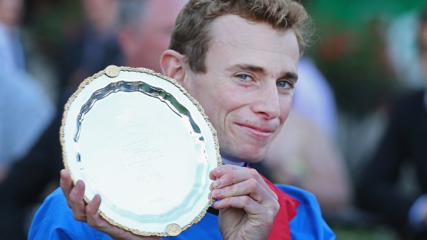 Spoils: Adelaide’s rider, Ryan Moore, poses with the Cox Plate.
