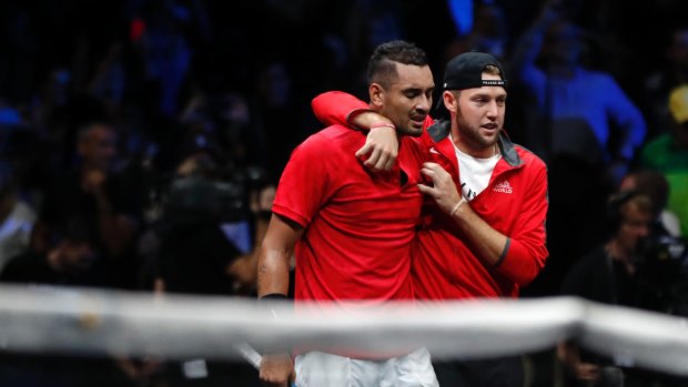 Nick Kyrgios is comforted by teammate Jack Sock after his loss to Roger Federer