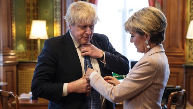 British Foreign Secretary Boris Johnson has his tie straightened by his Australian counterpart, Foreign Minister Julie Bishop.