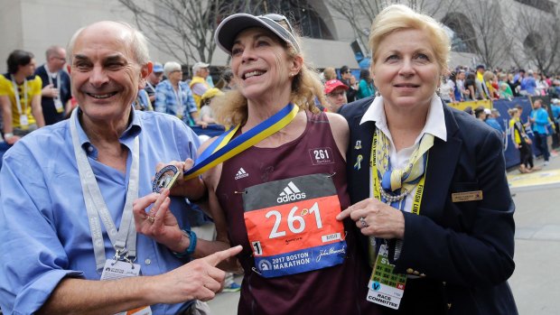 Kathrine Switzer, centre, the first woman entrant in the Boston Marathon 50 years ago, "survives" this year's marathon, and with the same bib number. 