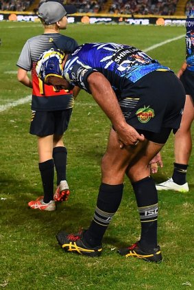 Injured: Johnathan Thurston clutches his left hamstring.
