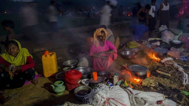 Rohingya Muslims, who crossed over from Myanmar into Bangladesh, prepare a meal at Taiy Khali refugee camp, in Bangladesh.