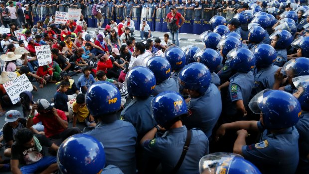 Security is tight in Manila as police confine a group of protesters along a street after attempting to march towards the venue for this week's APEC summit.
