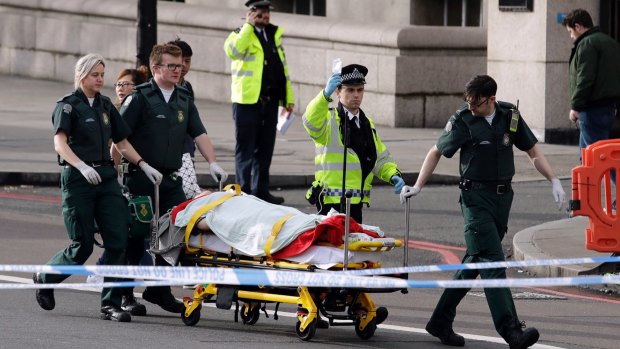 Emergency services help a victim of the Westminster Bridge attack.