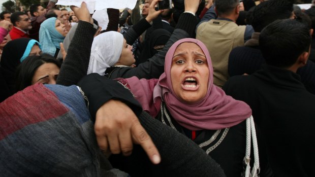A woman shouts as she blocks the entry of army tanks to Cairo's Tahrir Square during the Arab Spring in 2011.