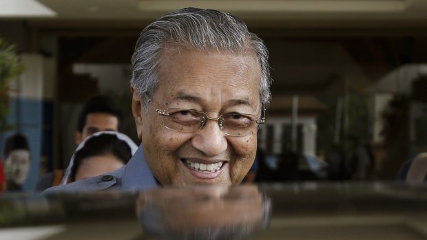 Mahathir Mohamad smiles after announcing he had quit the ruling UMNO party, saying it had been hijacked by his embattled successor, Najib Razak, to protect his interests.