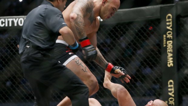 A referee rushes to break MMA heavyweight fighter Brandon Vera after knocking out with a kick challenger Paul Cheng in the first round of their One Championship bout in Manila.