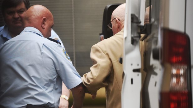 Roger Rogerson being led into the Supreme Court in Sydney on Monday.