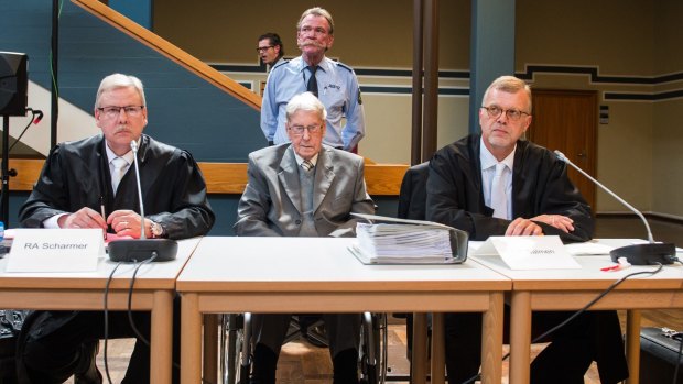 Reinhold Hanning sits between his lawyers Andreas Scharmer, left, and Johannes Salmen, right, in the courtroom.
