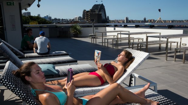 Backpackers Nicole Doyle and Melissa Esposito relax on the roof terrace of the YHA at Sydney's Rocks.  