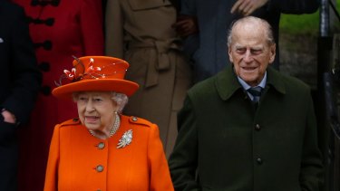 Britain's Queen Elizabeth II and Prince Philip, right, wait for their car following the traditional Christmas Day church service, at St. Mary Magdalene Church in Sandringham, England, Monday, Dec. 25, 2017. (AP Photo/Alastair Grant)