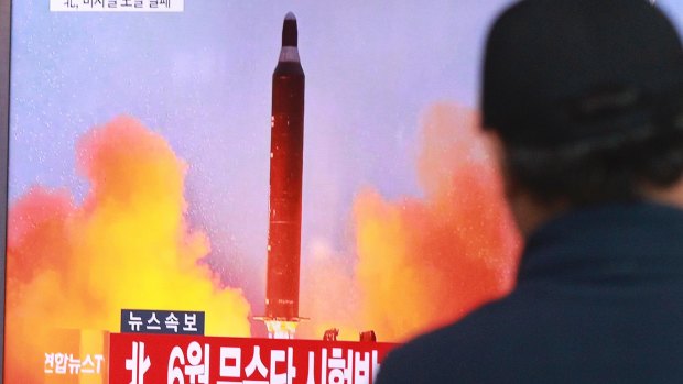 A man watches a TV news program showing a file image of a missile launch conducted by North Korea, at the Seoul Railway Station in Seoul.