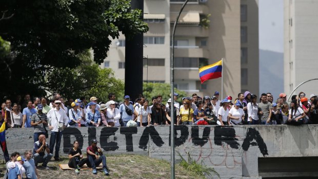 Anti-government demonstrators cross an overpass during a march against the Venezuelan government in Caracas on Wednesday.