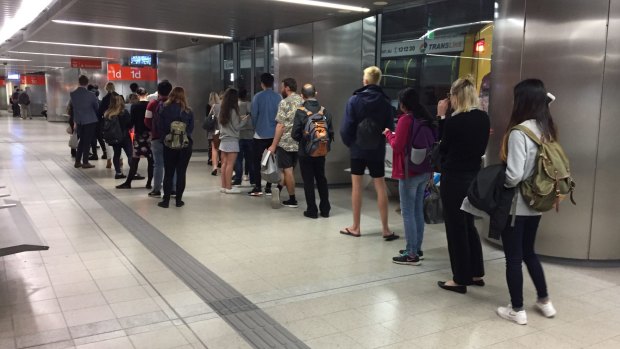 Commuters waiting for the 330 bus at the King George Square bus station.