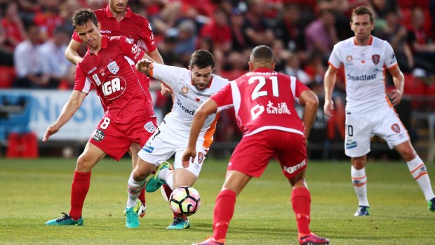 Traffic: Tommy Oar is brought down by Isaas of Adelaide United.