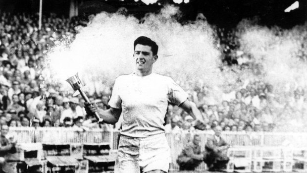 Ron Clarke carries the flame around the arena during the opening ceremony of the 1956 Melbourne Olympics. 