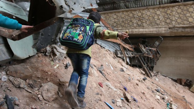 A boy navigates his way through rubble in Aleppo last week.