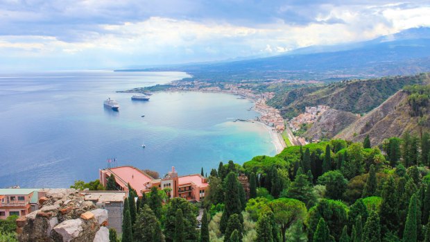 From the old ruis of Taormina, tourists can see the bay of Sicily.