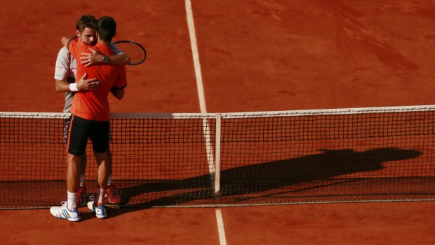 Switzerland's Stanislas Wawrinka hugs Serbia's Novak Djokovic after winning the 2015 men's French Open title.