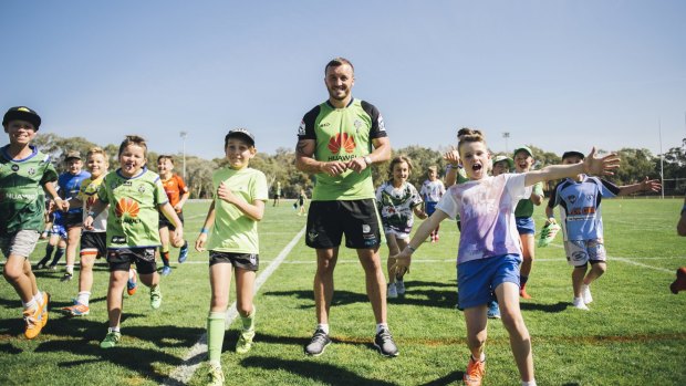 Canberra Raiders' Josh Hodgson with kids at the Raiders school holiday clinic. 