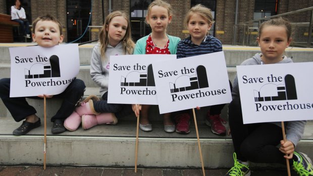 Children from the Webb and Carter families hold signs at the Save The Powerhouse Rally in 2015.