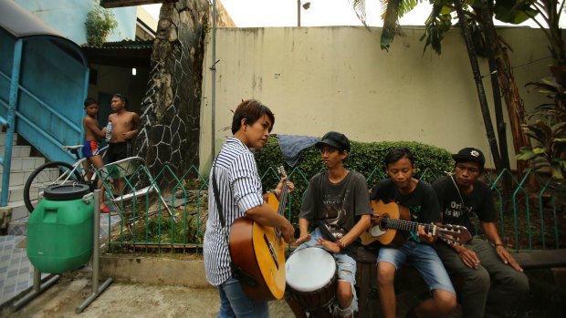 Titi Juwariyah, a mother of four from East Java, jams with her friends in Jakarta. 