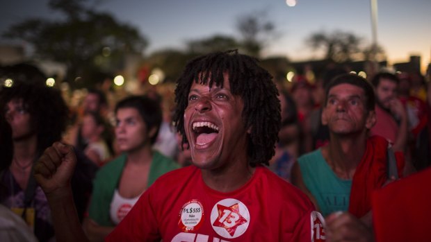 A pro-government demonstrator reacts as they watch an MP cast a vote not to impeach President Dilma Rousseff, on April 17.