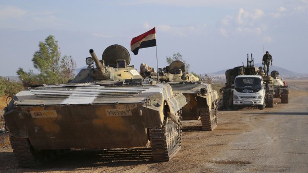 Syrian armoured vehicles get ready to move near the village of Morek in Syria on Wednesday. 