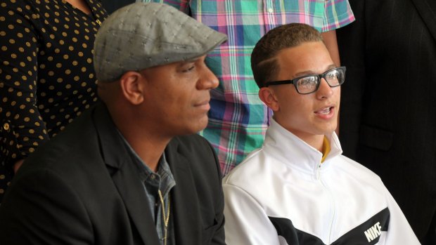 In this April 9 photo, Andre Harris, left, and Eric Harris' son Aidan Fraley speak about their brother and father, who was killed in Tulsa, Oklahoma, on April 2.
