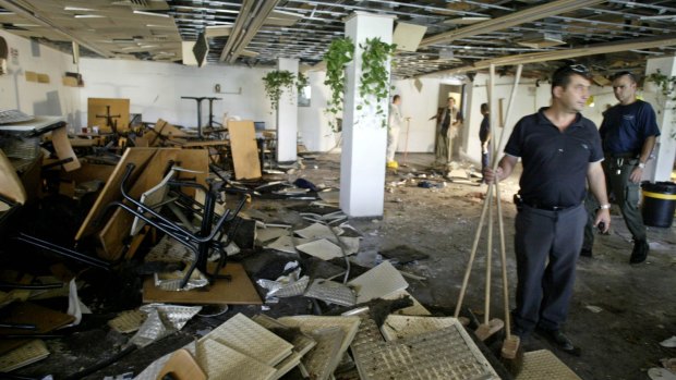 July 2002: workers clean the inside of a cafeteria hours after a bomb exploded at the Hebrew University in Jerusalem, killing nine people, four of them Americans, and wounding more than 70, in one of the attacks that formed the basis of the lawsuit.