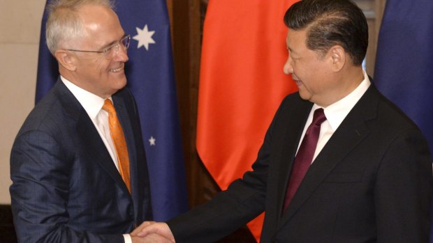 Prime Minister Malcolm Turnbull, left, and Chinese President Xi Jinping shake hands before a meeting in Beijing on Friday.