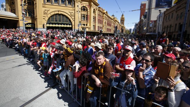 Crowds gather for the grand final day parade in 2014. 