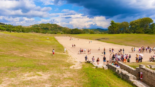 Tourists at the ancient Olympic Stadium in Olympia, Greece. 