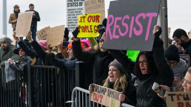 Protesters assemble at John F Kennedy International Airport in New York after two Iraqi refugees were detained while trying to enter the country.