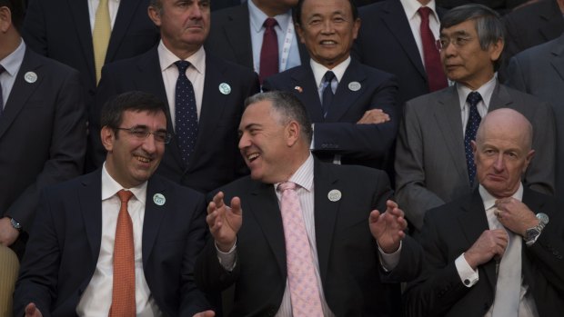 Happy news: Treasurer Joe Hockey (bottom centre) shares a joke with Turkey Deputy Prime Minister Cevdet Yilmaz (left) at the Ankara G20 summit. RBA governor Glenn Stevens (right) has a few things to ponder. 