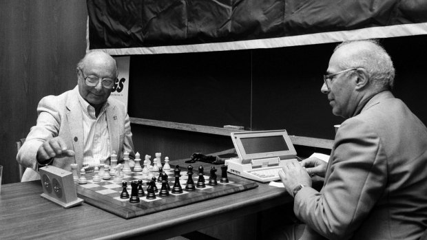 Arnold Denker, left, plays chess against a computer designed by Hans Berliner, right, at The New School in New York, in 1988.