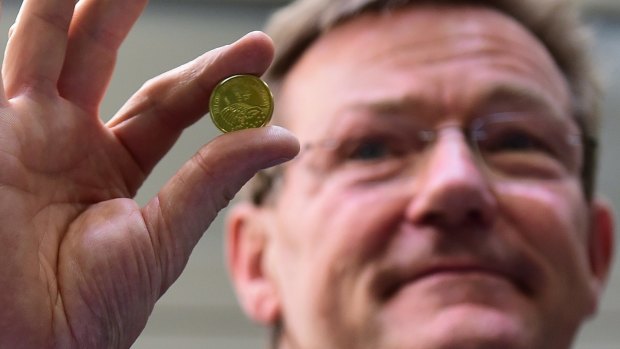 Belgian Finance Minister Johan Van Overtveldt holds a commemorative coin marking the 200th anniversary of The Battle of Waterloo.