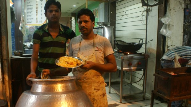 Roadside food vendors in Delhi sell chicken biryani - for Amrit Dhillon 's cow vigilante story