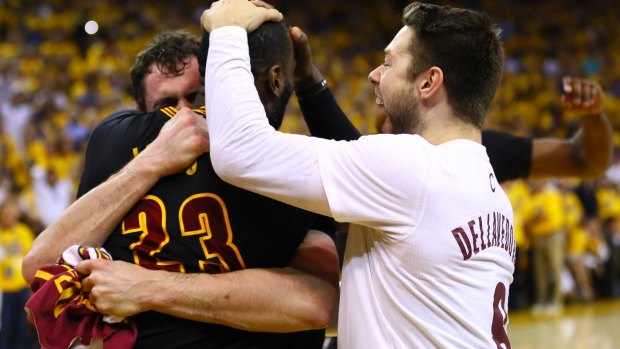 'Sweet, very sweet': Matthew Dellavedova celebrates with LeBron James and Kevin Love after defeating the Golden State Warriors. 