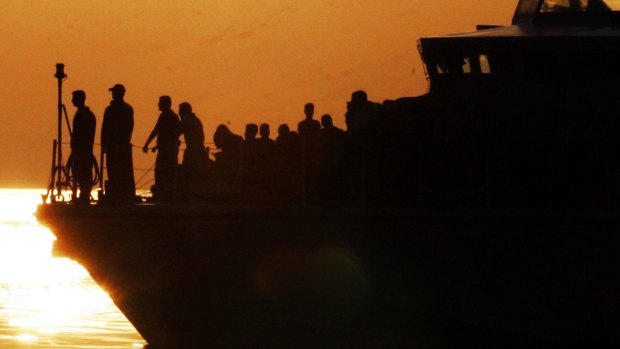 Syrian refugees being escorted by patrol boat to the ship, Eleftherios Venizelos, in Kos' main port. The ship will house more than 2,500 refugees and migrants and be used as a registration centre.