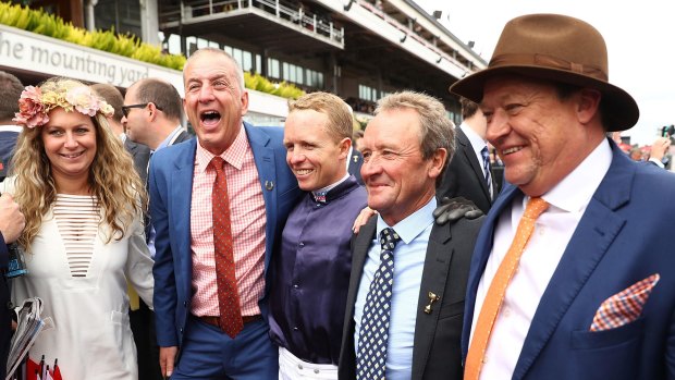 Winning combination: Kerrin McEvoy celebrates with connections after he rode Almandin to win the Melbourne Cup.