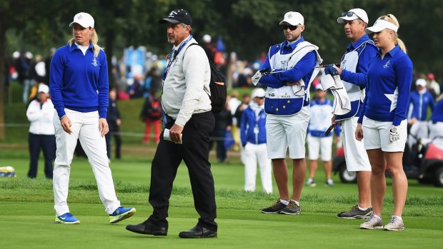 Suzanne Pettersen and Charley Hull of team Europe explain to LPGA referee Dan Maselli that Alison Lee's putt was not conceded on the 17th green in September 2015.