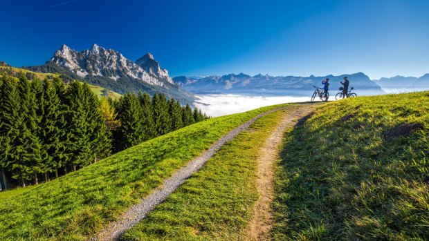 Cyclists look across towards the Mythen peaks in central Switzerland.