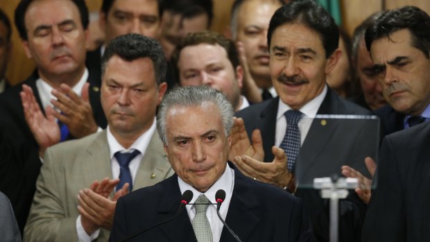 Brazil's interim President Michel Temer (centre) attends a signing ceremony for new government ministers on May 12.