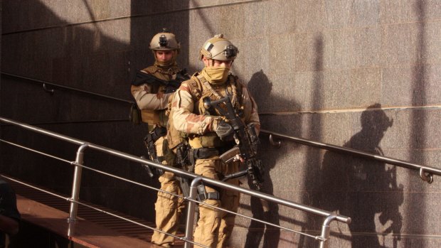 Soldiers leave the Radisson Blu hotel, after assisting Mali soldiers during an attack by gunmen on the hotel in Bamako, Mali.