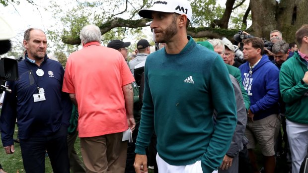 Huge blow: Dustin Johnson heads back to the clubhouse after pulling out with a back injury.